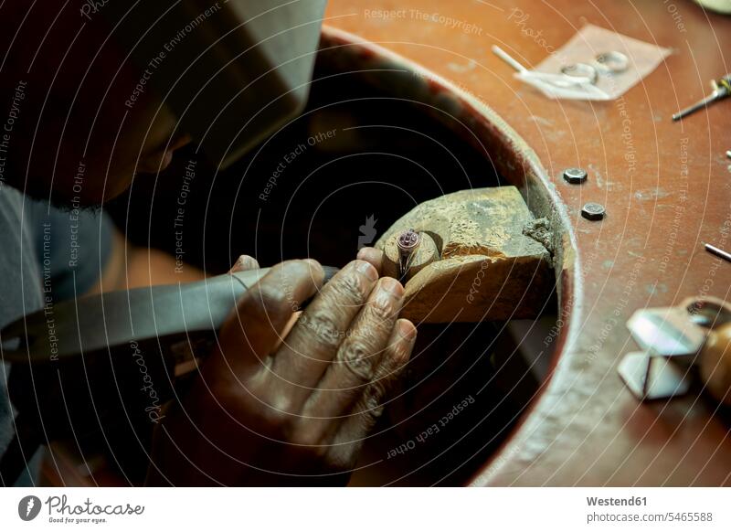 Man repairing a ring with a missing diamond human human being human beings humans person persons African black black ethnicity coloured 1 one person only