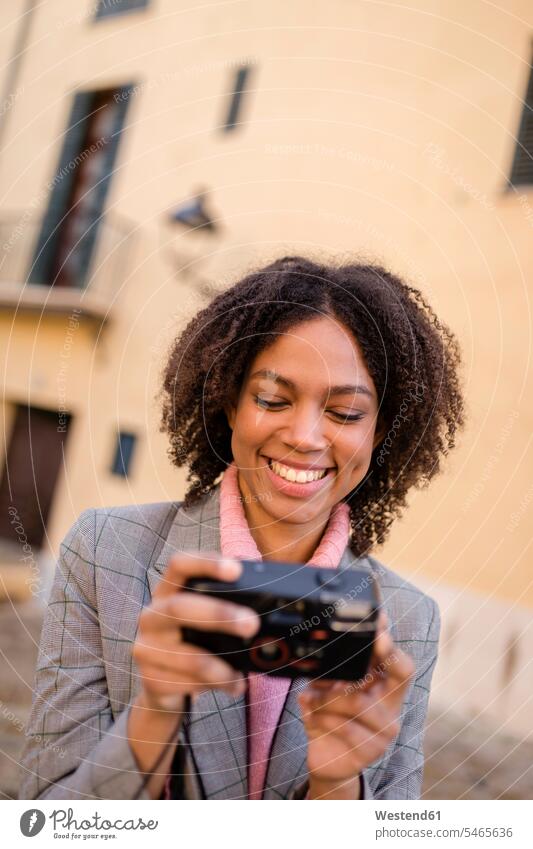 Portrait of laughing young woman looking at camera females women portrait portraits Laughter eyeing cameras Adults grown-ups grownups adult people persons