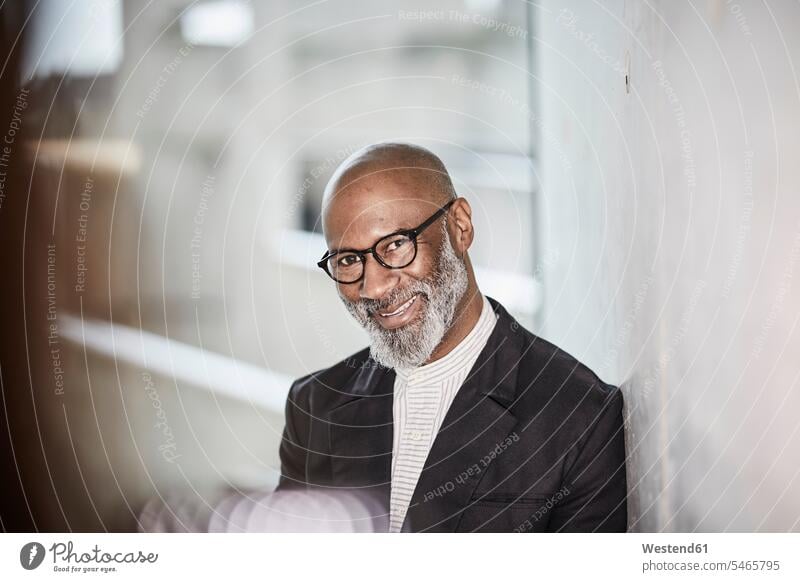 Portrait of smiling mature businessman with grey beard wearing glasses Businessman Business man Businessmen Business men portrait portraits males smile