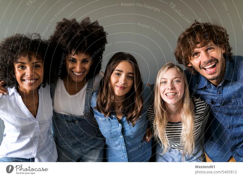 Group portrait of happy friends happiness portraits friendship positive embracing embrace Embracement hug hugging community Companionship five people 5 laughing