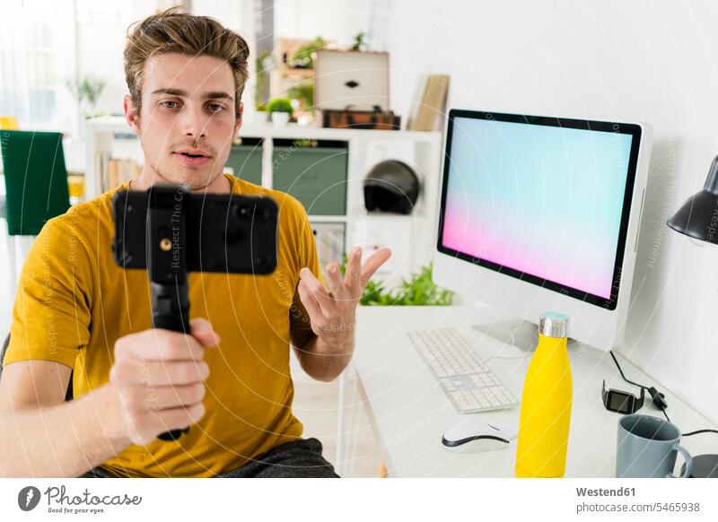 Fitness trainer talking on live streaming while sitting at home color image colour image indoors indoor shot indoor shots interior interior view Interiors day