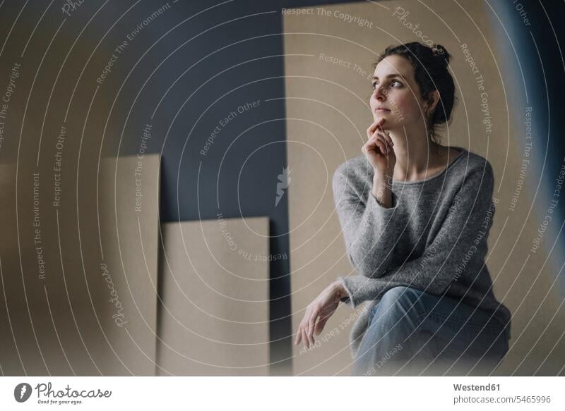 Portrait of pensive young woman jumper sweater Sweaters Seated sit contemplative Reflective thoughtful Attractiveness beautiful good-looking Handsome pretty