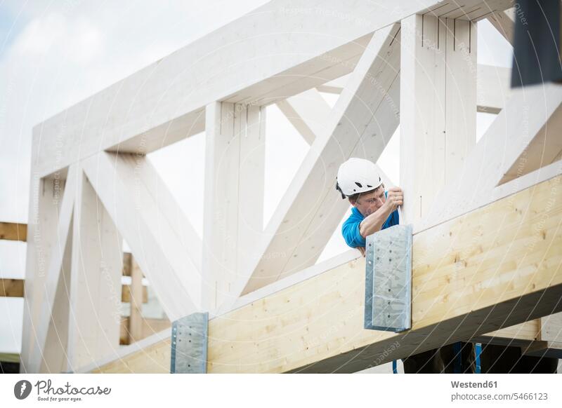 Austria, worker fixing roof construction helmet helmets Protective Headwear Job Occupation Work positioning man men males Roof fastening Adults grown-ups