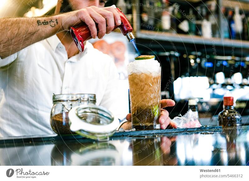 Close-up of barkeeper preparing a cocktail bartender barman bartenders barkeepers Food Preparation preparing food Cocktail Cocktails Long Drinks preparation