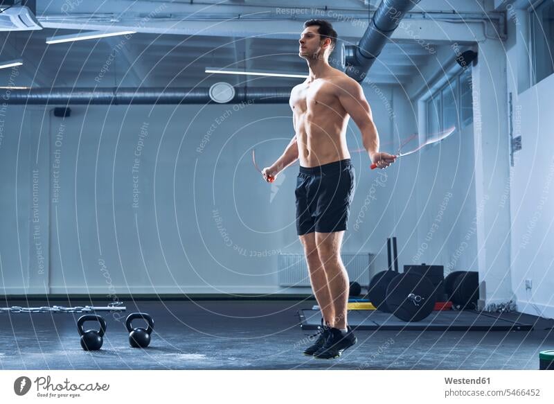 Female athlete exercise with a jump rope in sport gym. Active woman workout  in fitness club Stock Photo - Alamy