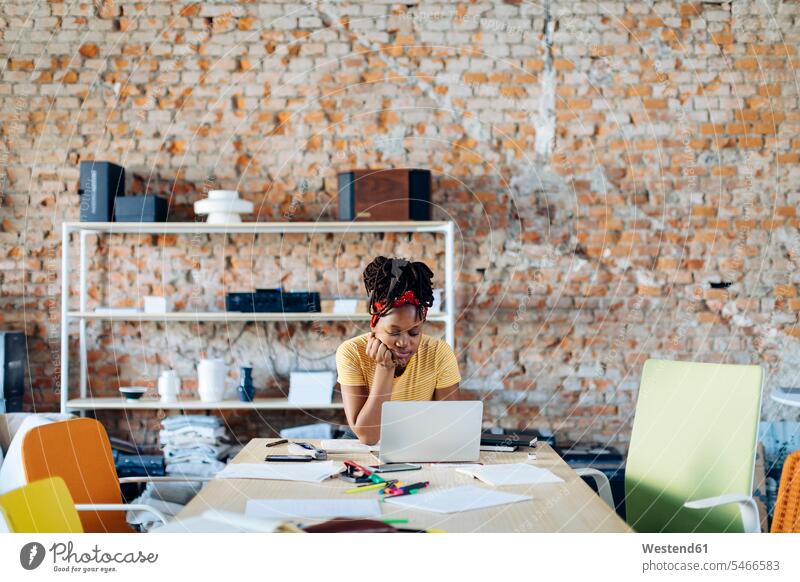 Young woman sitting at table using laptop Wireless Communication Wireless Connection Wireless Technology indoor indoor shot indoor shots interior interior view