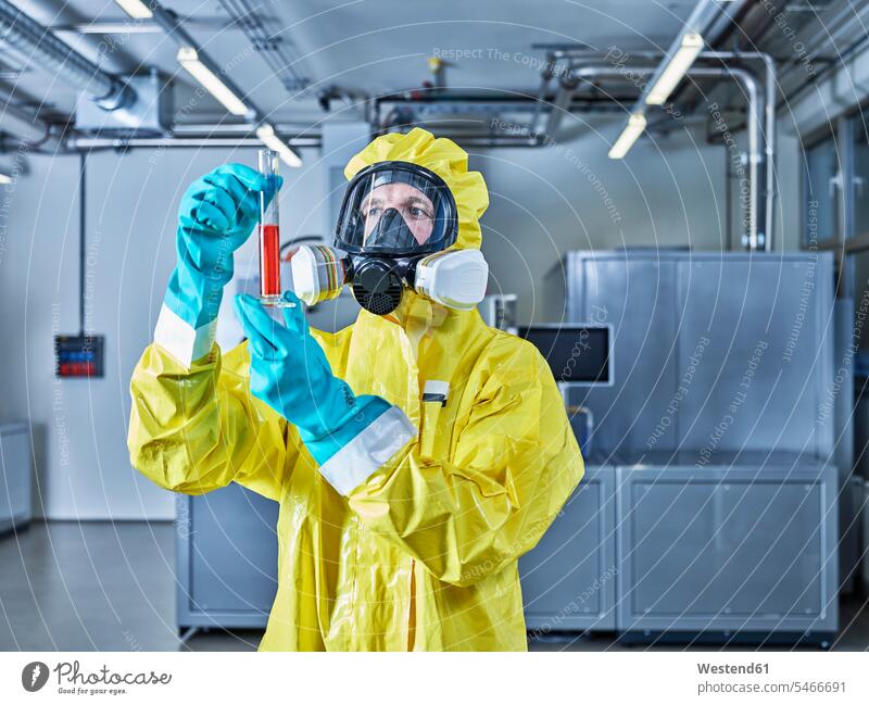 Chemist working in industrial laboratory, checking test tube chemist At Work Protective Suit Chemical Laboratory natural scientist science sciences scientific