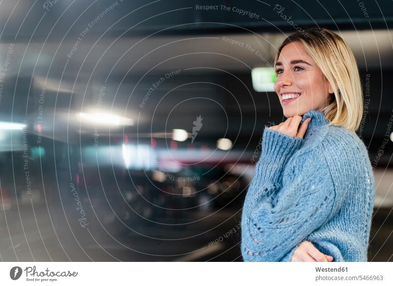 Portrait of a smiling young woman in a parking garage human human being human beings humans person persons caucasian appearance caucasian ethnicity european 1