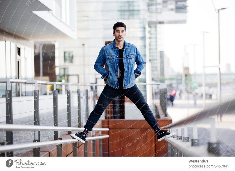 Germany, Cologne, young man at Rheinau harbour men males Adults grown-ups grownups adult people persons human being humans human beings Middle Eastern Ethnicity