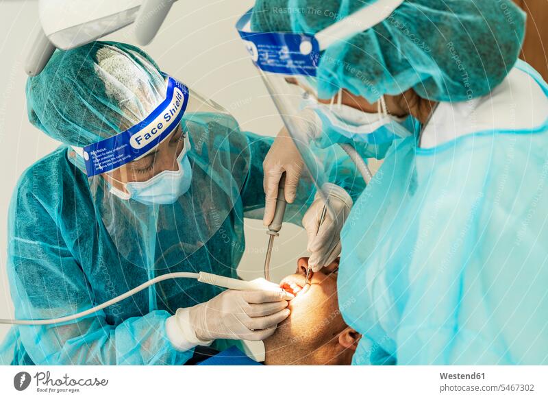 Doctor and female nurse examining patient in dentist's clinic color image colour image indoors indoor shot indoor shots interior interior view Interiors Spain