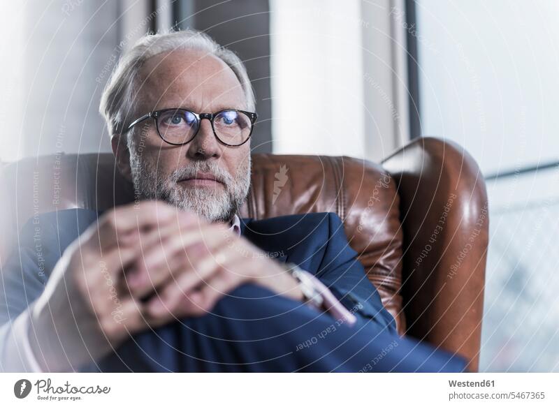 Portrait of mature businessman sitting in leather armchair Arm Chairs armchairs Businessman Business man Businessmen Business men Seated portrait portraits