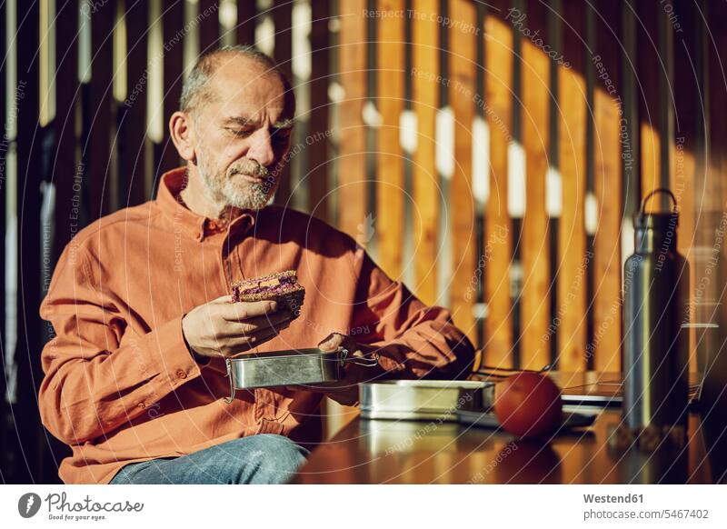 Relaxed businessman having sustainable lunch in his office human human being human beings humans person persons caucasian appearance caucasian ethnicity