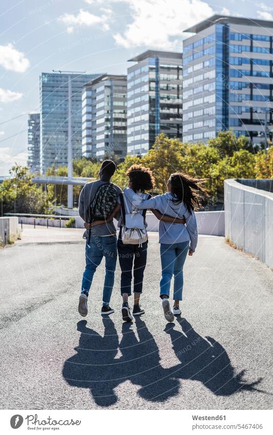 Three friends exploring the city, walking down the street, arm in arm going urban urbanity Exploration explore streets City Street City Streets urban scene town