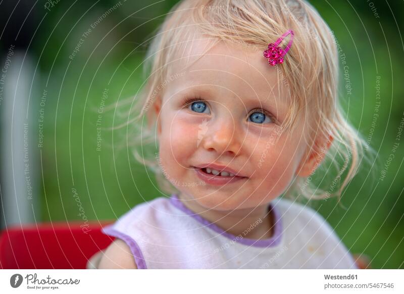 Portrait of blond little girl with bib and pink haipin smiling smile bibs Baby Bib hairpin hairpins nature natural world magenta females girls one person 1