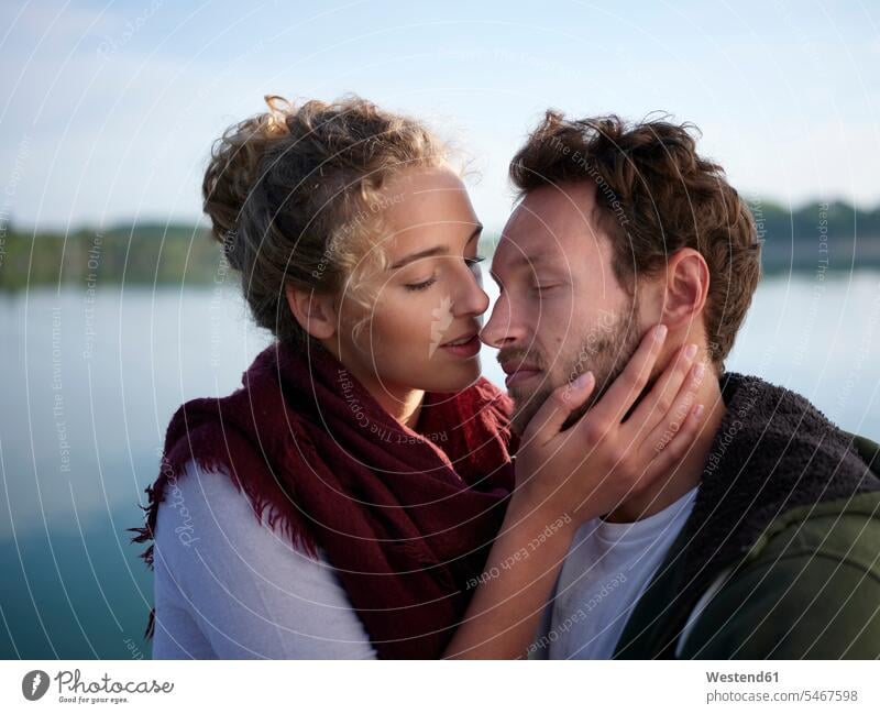 Romantioc couple kissing at lake kisses seasons spring season Spring Time springtime happy Emotions Feeling Feelings Sentiment Sentiments loving closeness