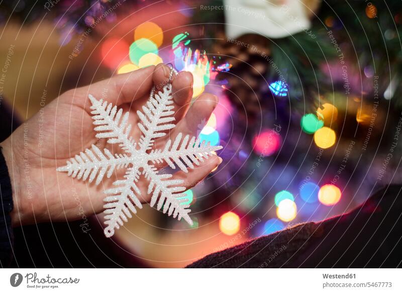 Woman's hand holding Christmas ornament, close-up human hand hands human hands woman females women Christmas Ornament Christmas decoration trimmings