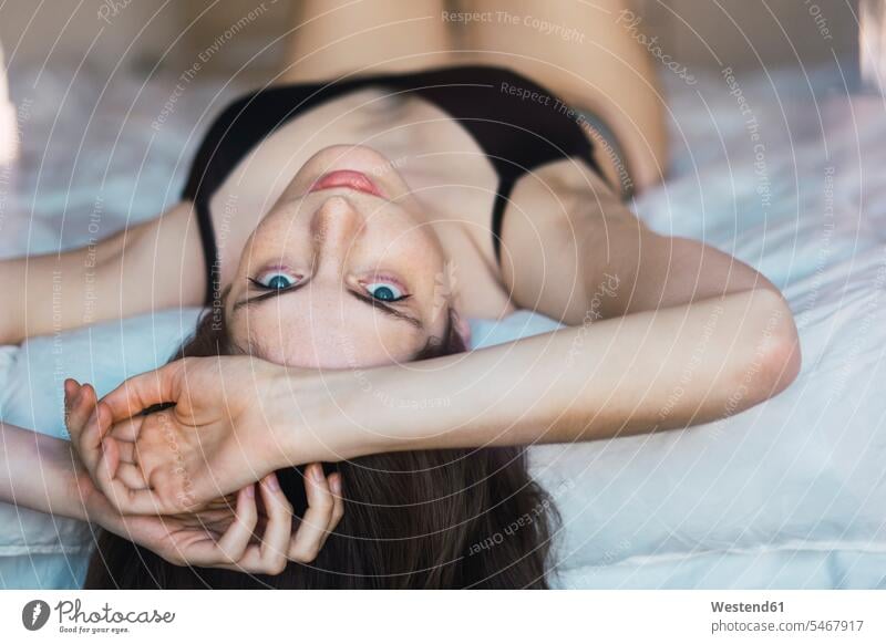 Pink And Black Bras On A Bed Stock Photo, Picture and Royalty Free