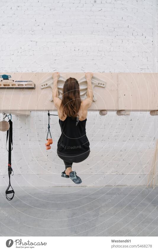 Woman doing pull-ups before climbing (value=0) back view view from the back full body full shot full-body full-length human human being human beings humans