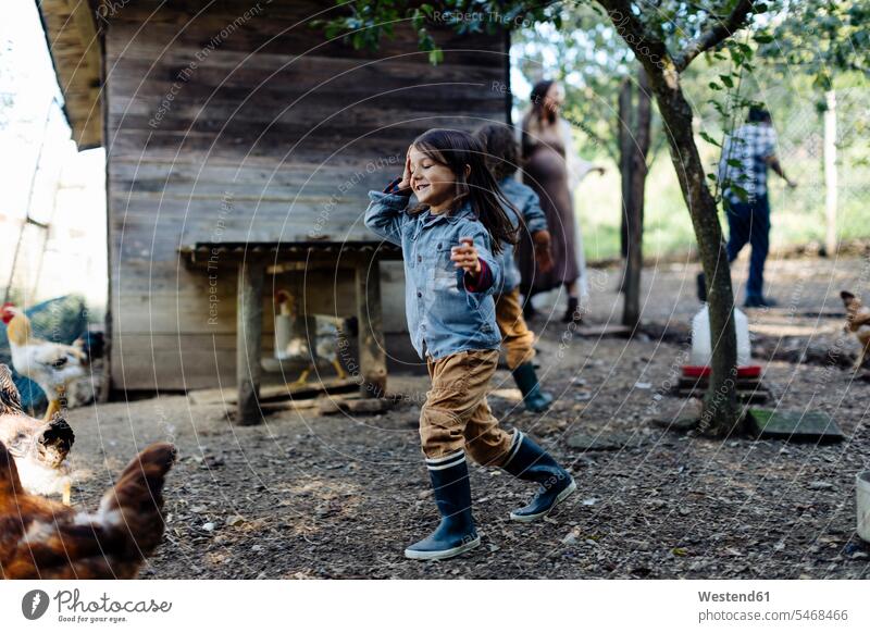 Family in a chicken pen on an organic farm human human being human beings humans person persons caucasian appearance caucasian ethnicity european Group