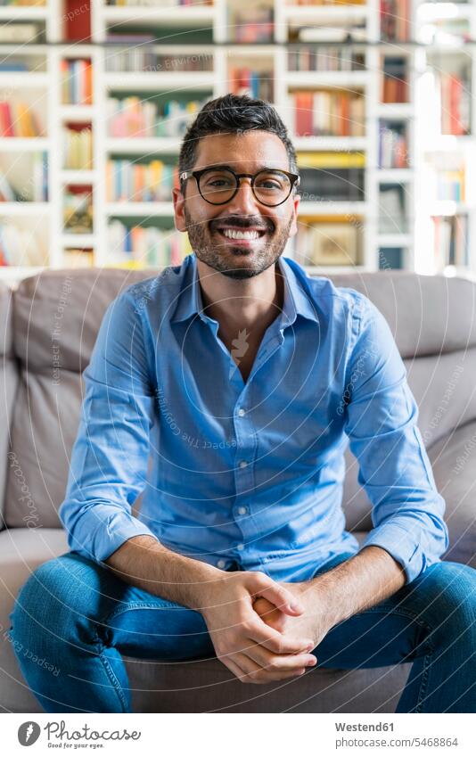 Portrait of happy young man sitting on the couch at home human human being human beings humans person persons caucasian appearance caucasian ethnicity european