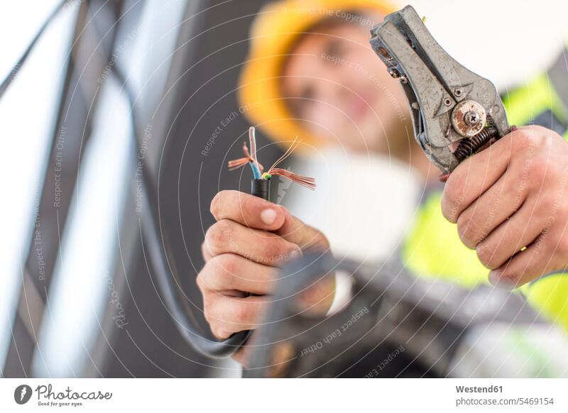 Close-up of electrician working with wire cutter Electrician At Work Wire Cutter tool tools Tool Kit device devices Part Of partial view cropped