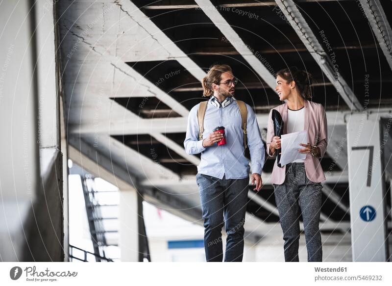 Young business people discussing document on their wa to work Preparation prepare preparing businesspeople businesswoman businesswomen business woman