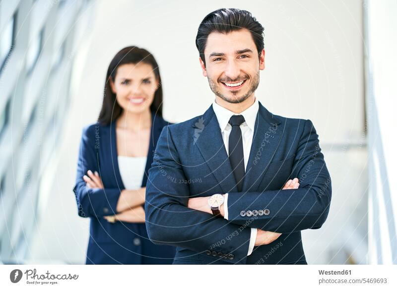 Portrait of smiling businessman and businesswoman businesswomen business woman business women portrait portraits Businessman Business man Businessmen