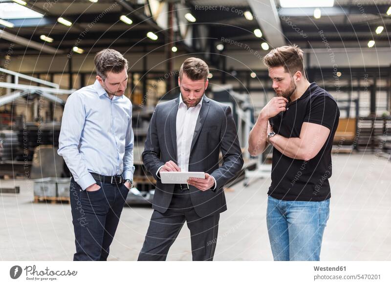 Three men sharing tablet on factory shop floor man males share factories digitizer Tablet Computer Tablet PC Tablet Computers iPad Digital Tablet