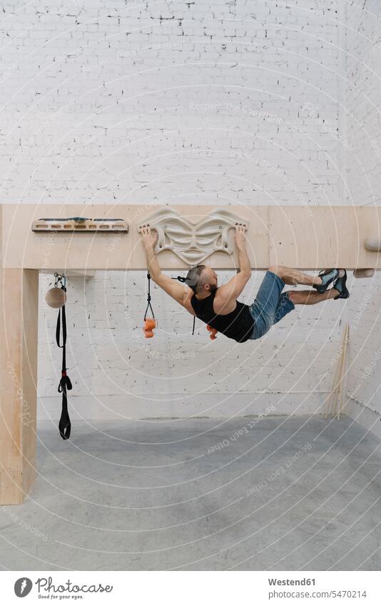 Man doing stretching exercises before climbing (value=0) in shape human human being human beings humans person persons caucasian appearance caucasian ethnicity