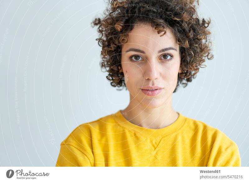 Portrait of confident woman wearing yellow sweater Self-confidence self-confident poised Self-Assured Self-Assurance pullover jumper Sweaters portrait portraits