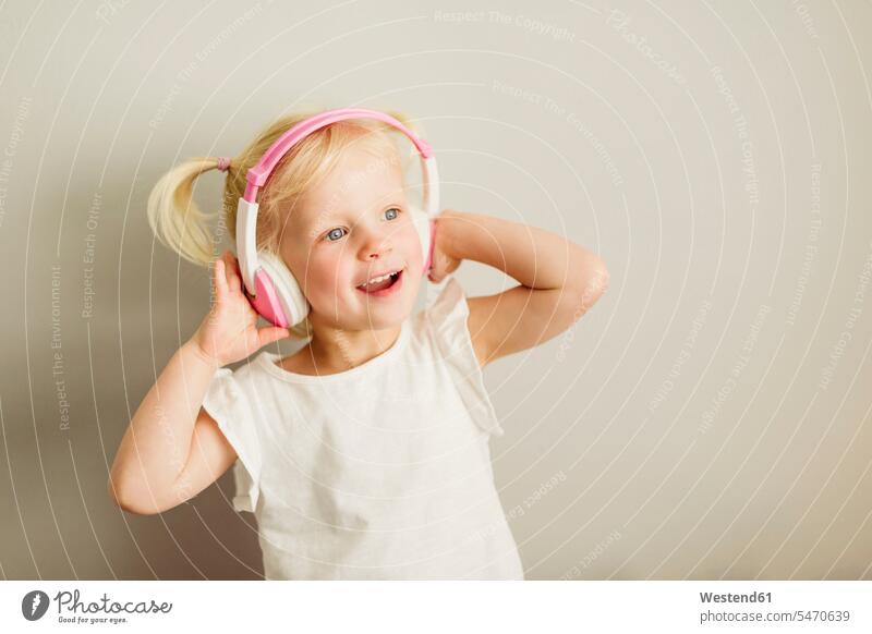 Portrait of little girl listening music with headphones dancing headset hearing females girls portrait portraits dance child children kid kids people persons