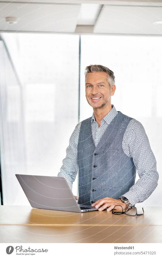 Portrait of smiling businessman, using laptp human human being human beings humans person persons caucasian appearance caucasian ethnicity european 1