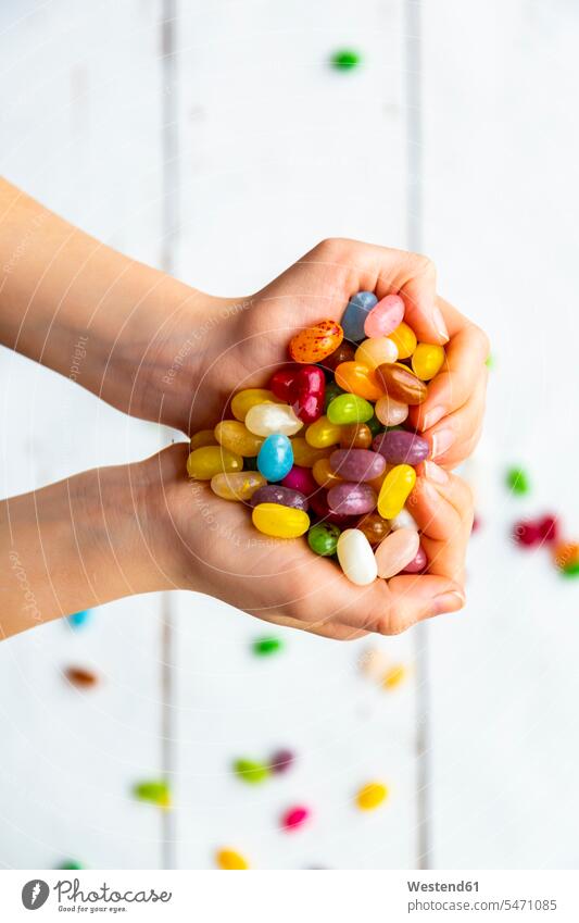 Colourful sweet jellybeans in hands, forming a heart Handful abundance Abundant Love loving human hand human hands jelly bean jelly beans girl females girls