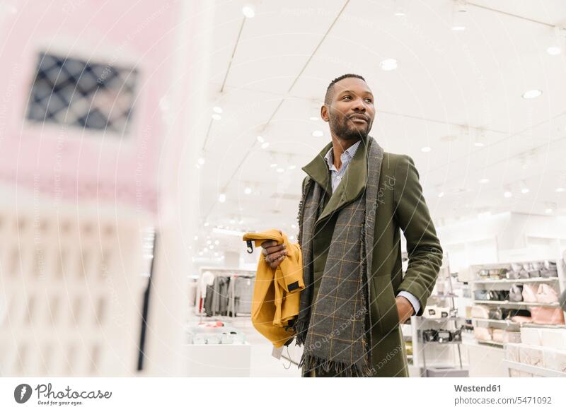 Stylish man shopping in a clothes store human human being human beings humans person persons client clientele clients customers business life business world