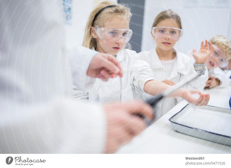 Pupils in science class watching teacher experimenting classmates school schools instructor teachers student pupils effort attempt looking view seeing viewing