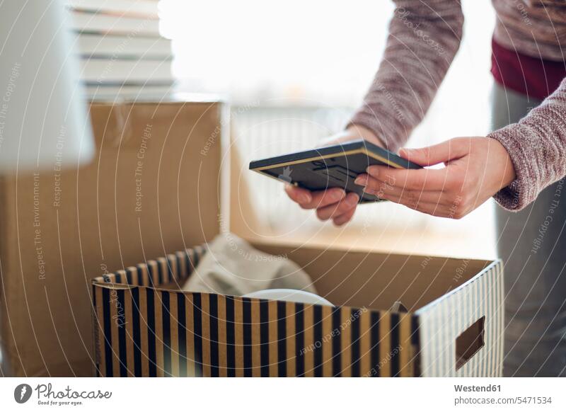 Close-up of woman unpacking cardboard box in new home human human being human beings humans person persons caucasian appearance caucasian ethnicity european 1