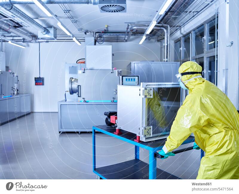 Chemist working in industrial laboratory clean room Chemical Laboratory At Work Protective Suit chemist sterile clothing hygiene natural scientist science