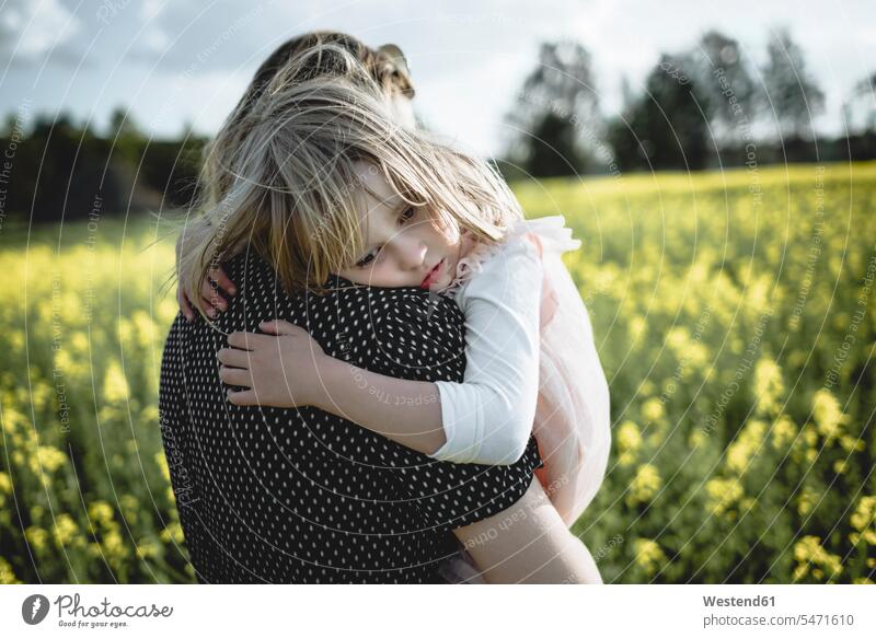 Portrait of little girl on her mother's arms in rape field mommy mothers ma mummy mama portrait portraits females girls canola fields Rapeseed Field rape fields