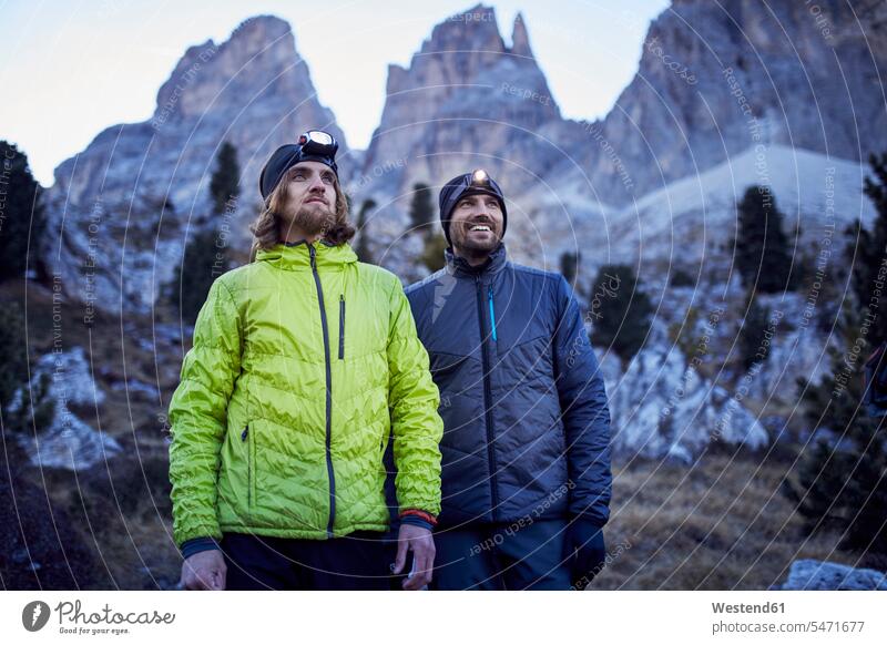 Two confident men wearing headlamps in the mountains Head Lamp Head Torch man males friends mate happiness happy Adults grown-ups grownups adult people persons