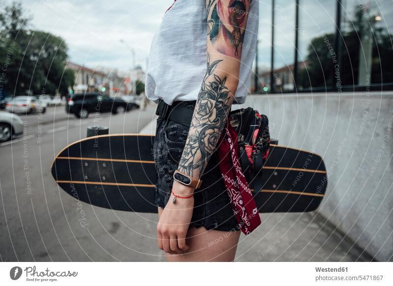 Close-up of young woman holding carver skateboard on the pavement Skate Board skateboards females women Side Walk Adults grown-ups grownups adult people persons