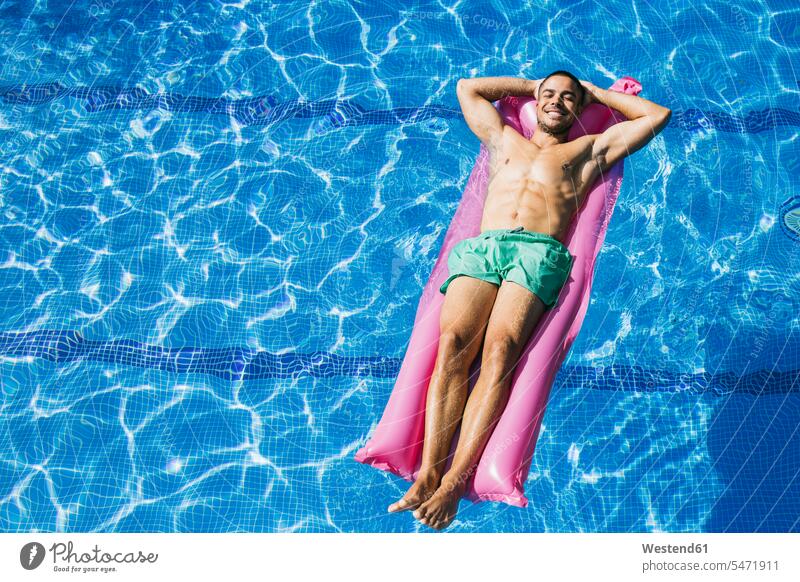 Man In Racing Briefs Beside Swimming Pool Hands Behind Head High-Res Stock  Photo - Getty Images