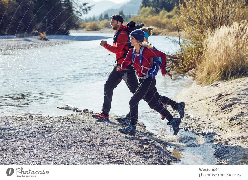 Group of friends hiking jumping over river mate River Rivers hike Leaping friendship water waters body of water jumps Recreational Pursuit