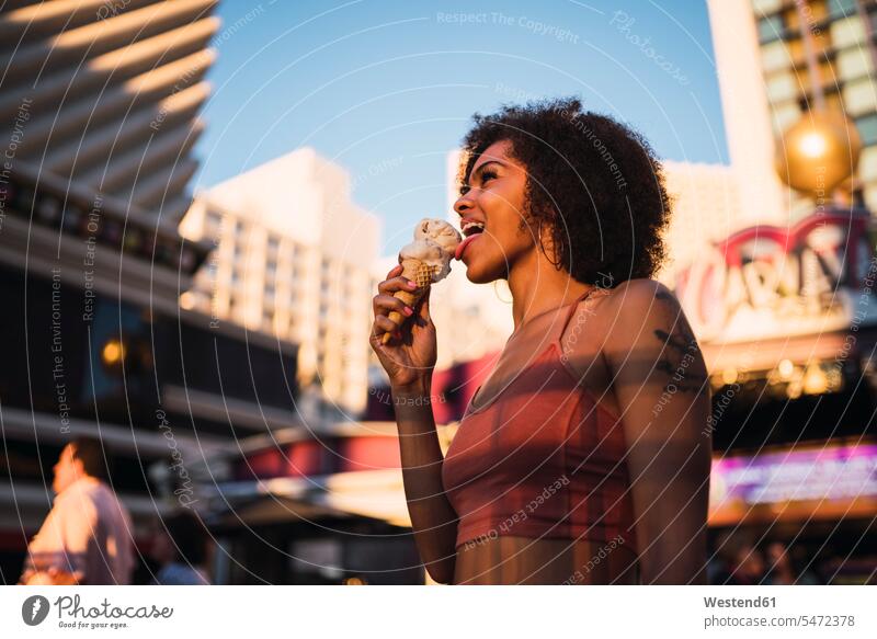 USA, Nevada, Las Vegas, happy young woman eating ice cream in the city females women icecream Ice Creams ice-cream town cities towns happiness Adults grown-ups