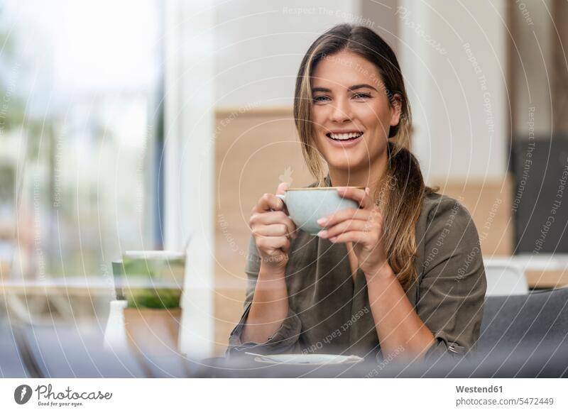 Young businesswoman with coffee cup in a cafe human human being human beings humans person persons caucasian appearance caucasian ethnicity european 1