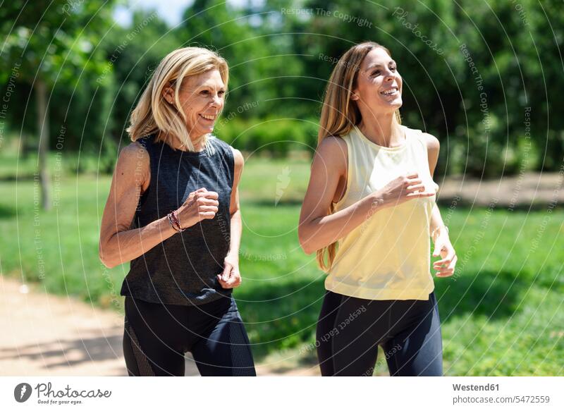 Two Women Running In Park Stock Photo, Picture and Royalty Free