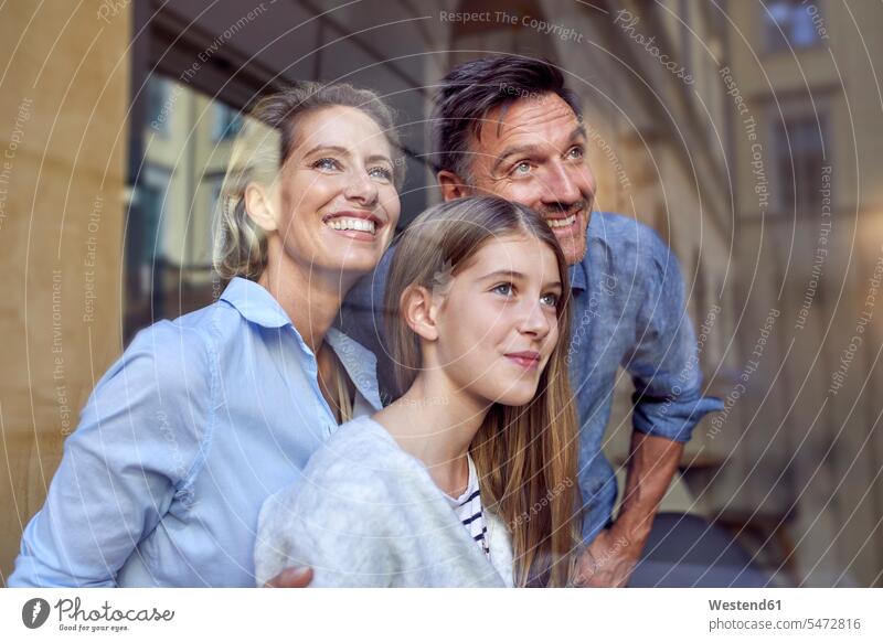 Portrait of happy family behind windowpane window glass window glasses windowpanes Window Pane portrait portraits happiness families windows people persons
