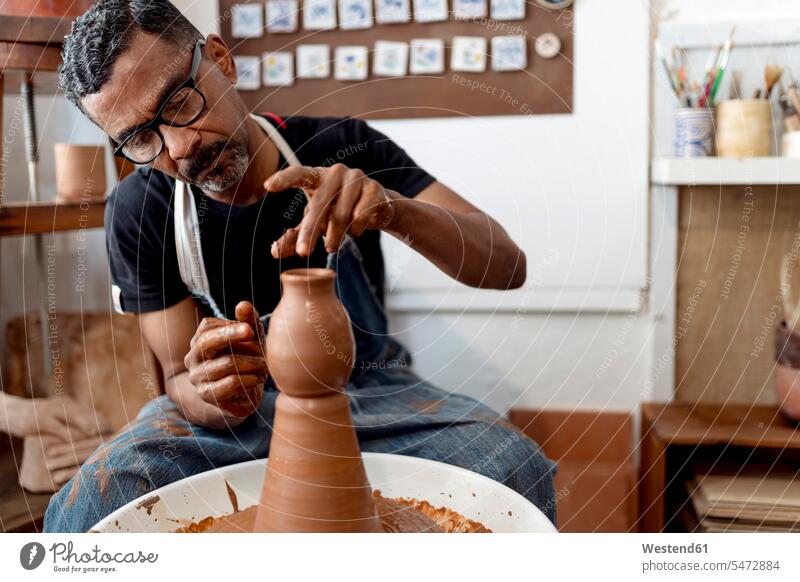 Pottery making from brown clay in ceramic workshop stock photo