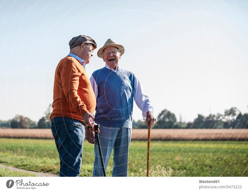 Two old friends standing in the fields, talking about old times Stroll walk walking going speaking laughing Laughter Best Friend Best Friends Best Pal Field