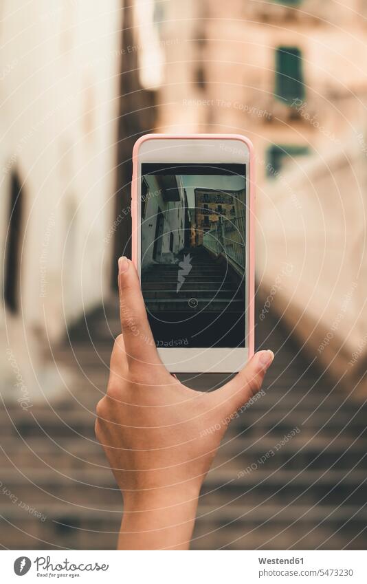 Malta, Valletta, Hand of woman taking cell phone picture of a street streets City Street City Streets hand human hand hands human hands Smartphone iPhone