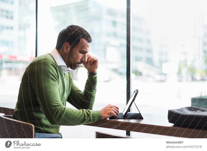 Business man using tablet in cafe men males use digitizer Tablet Computer Tablet PC Tablet Computers iPad Digital Tablet digital tablets wireless